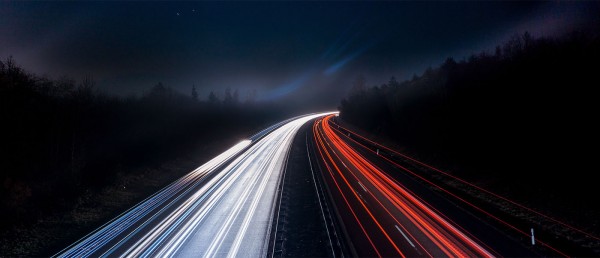 truck headlights and tail lights on highway at night
